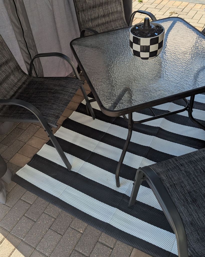Black and white striped outdoor patio rug