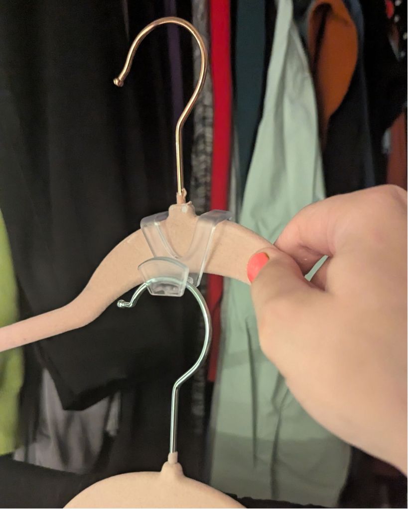 Clear plastic space-saving hanger connector stacking two closet hangers