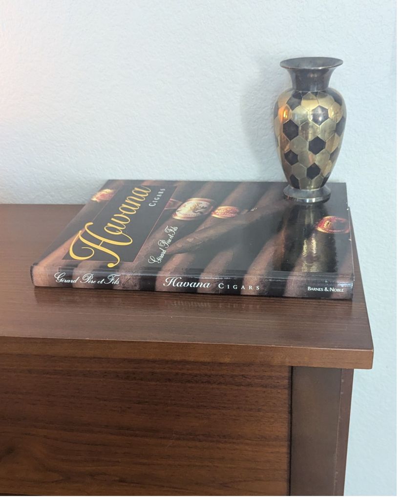 Havana Cigars coffee table book beside a black and gold hexagon vase