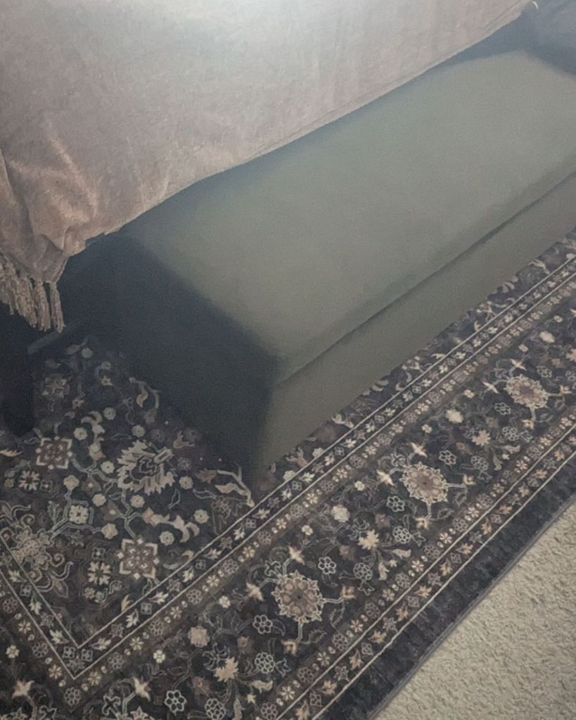 Vintage Persian-style floral area rug in bedroom